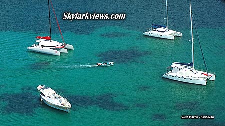 three catamarans and one sailboat